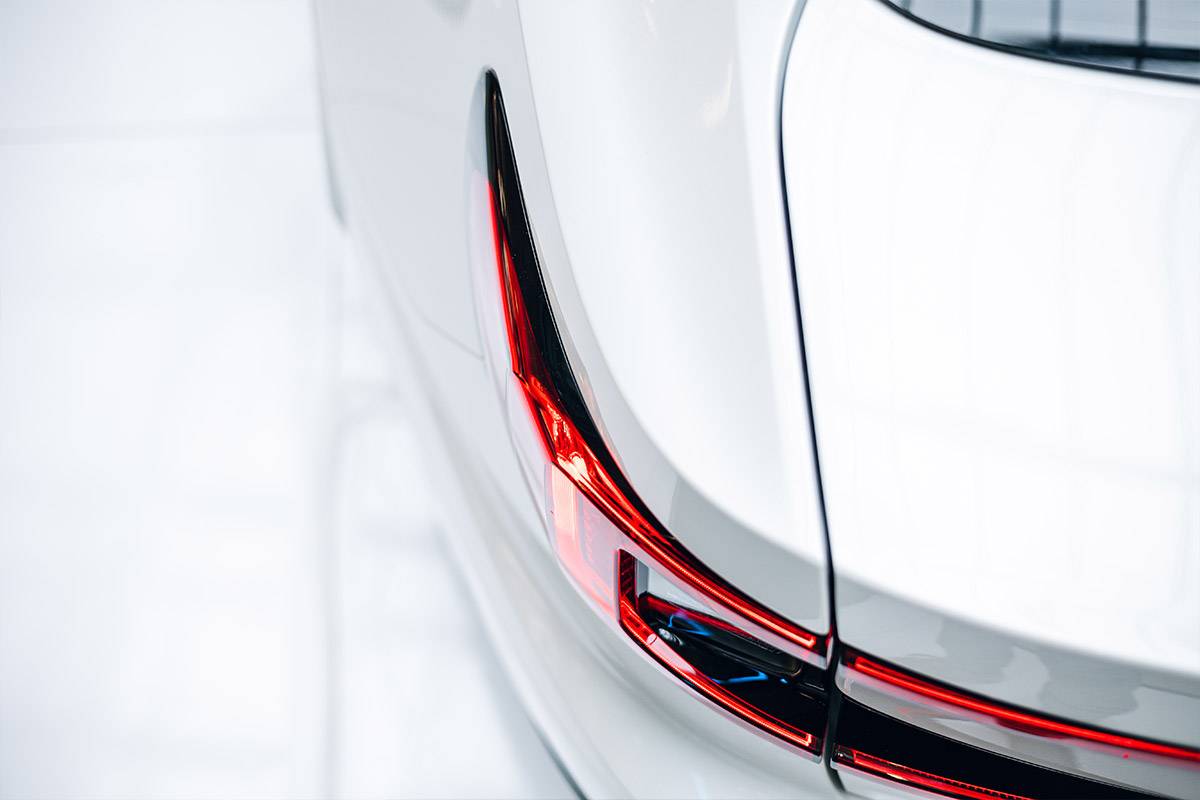 Close-up of the red tail light of a white car