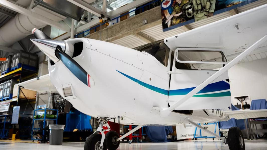 Single-engine training aircraft positioned in the aviation hangar