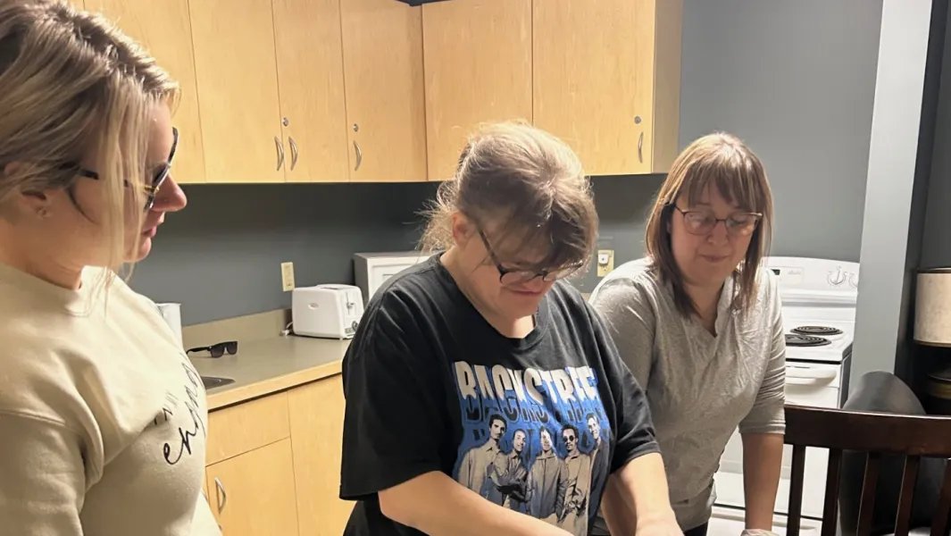 Students practicing cooking skills in a life-skills kitchen