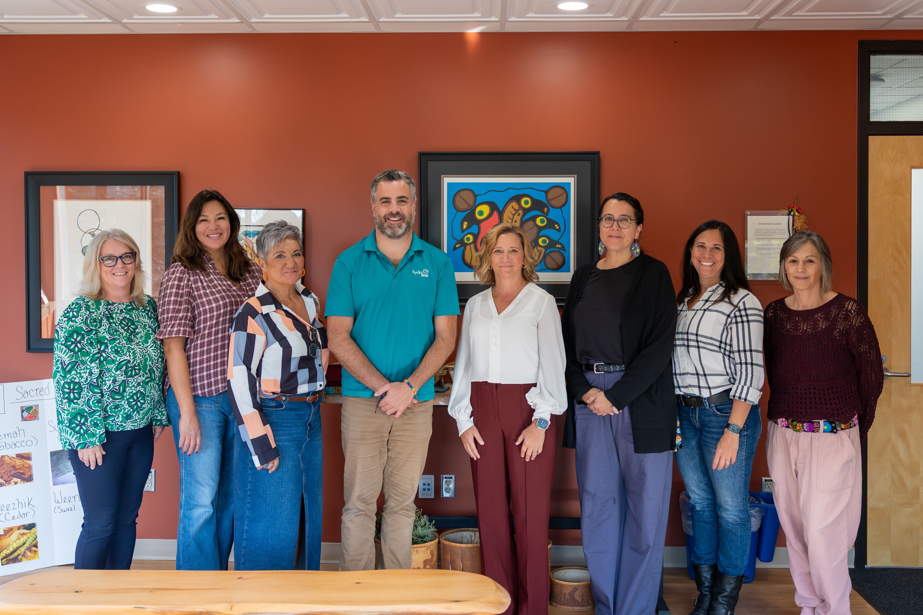 College and Hydro One staff standing together in the updated smudging room supporting campus Indigenization.