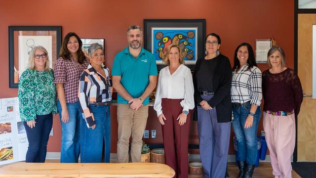 College and Hydro One staff standing together in the updated smudging room supporting campus Indigenization.