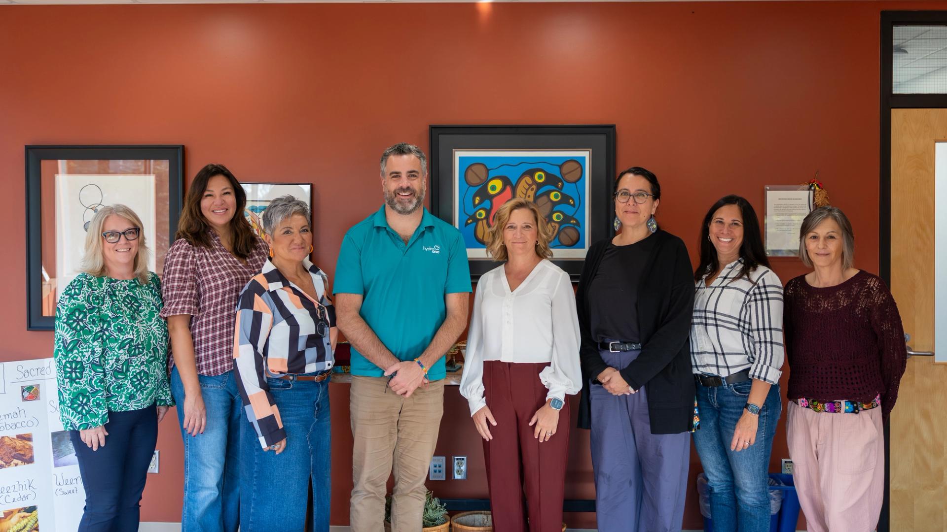 College and Hydro One staff standing together in the updated smudging room supporting campus Indigenization.