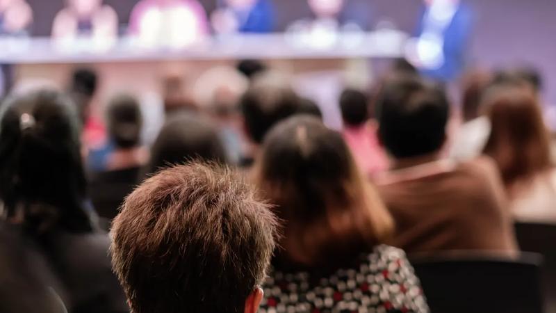 Audience seated and listening to a panel discussion