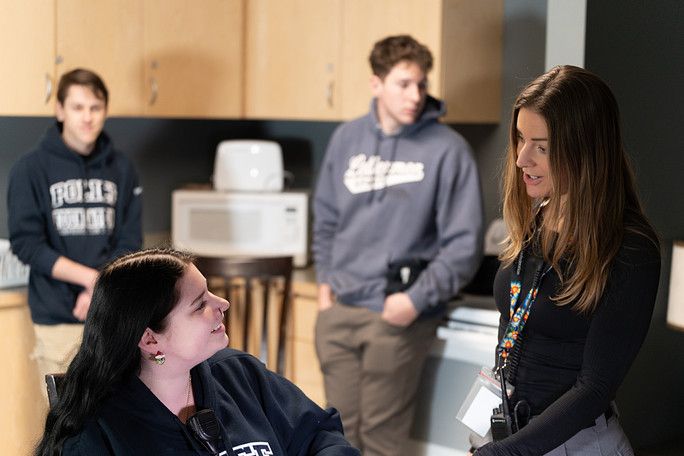 Instructor speaking with students during an in-class discussion