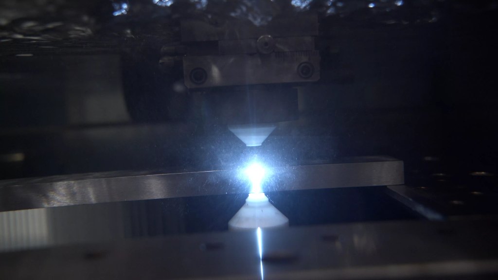 CNC machine emitting a bright cutting light