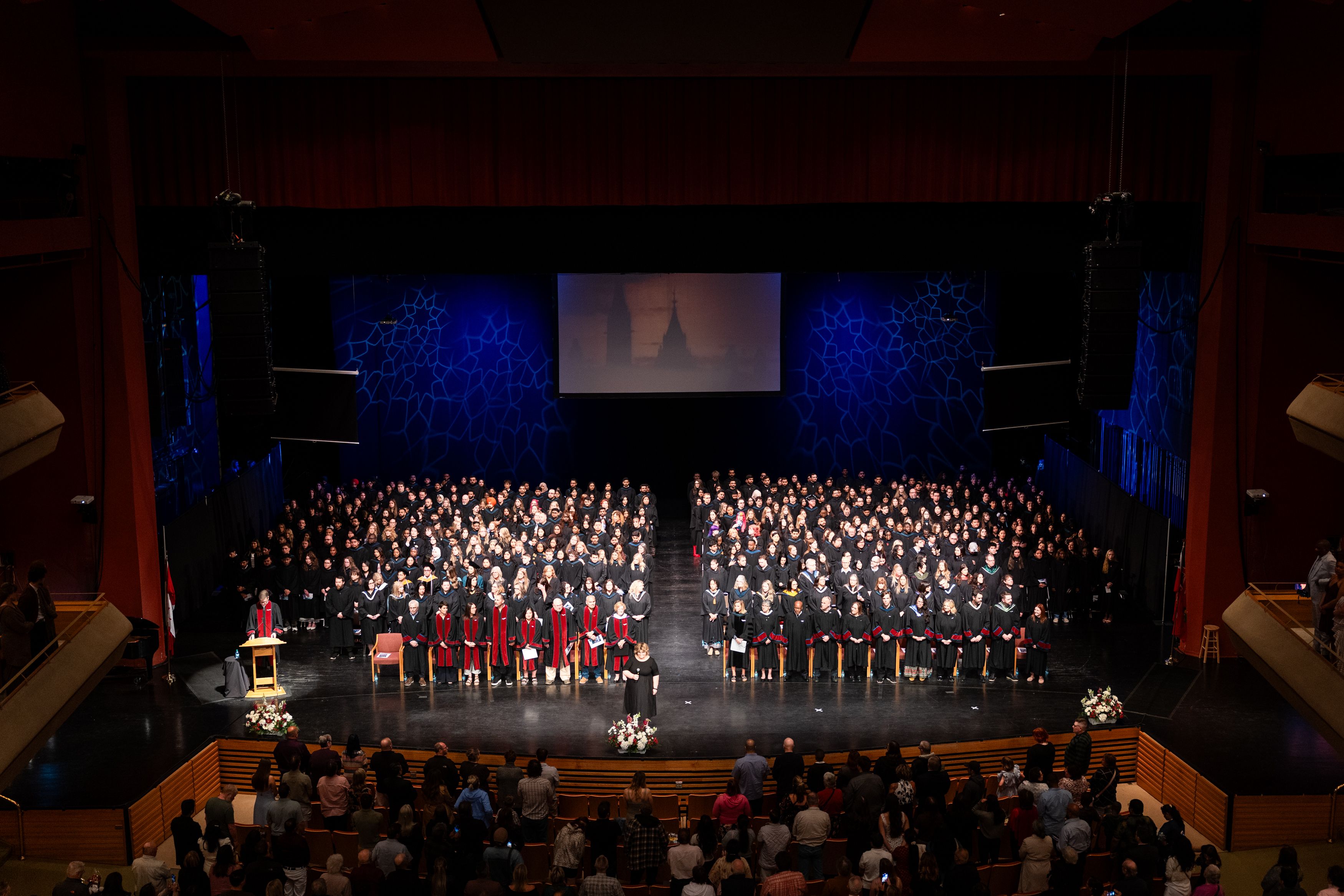 Graduates and faculty gather on stage during Confederation College’s 2026 convocation ceremony