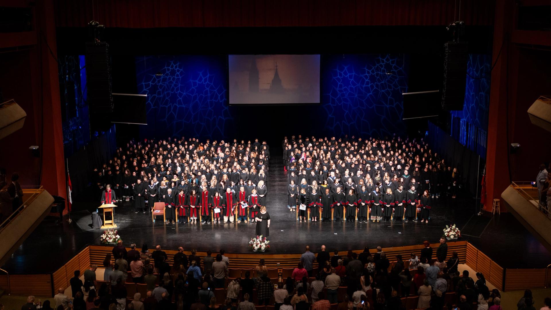 Graduates and faculty gather on stage during Confederation College’s 2026 convocation ceremony