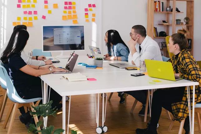 Team brainstorming session with sticky notes on wall