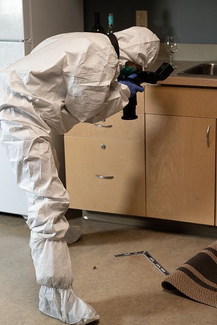 Forensic investigator documents evidence in a simulated crime scene