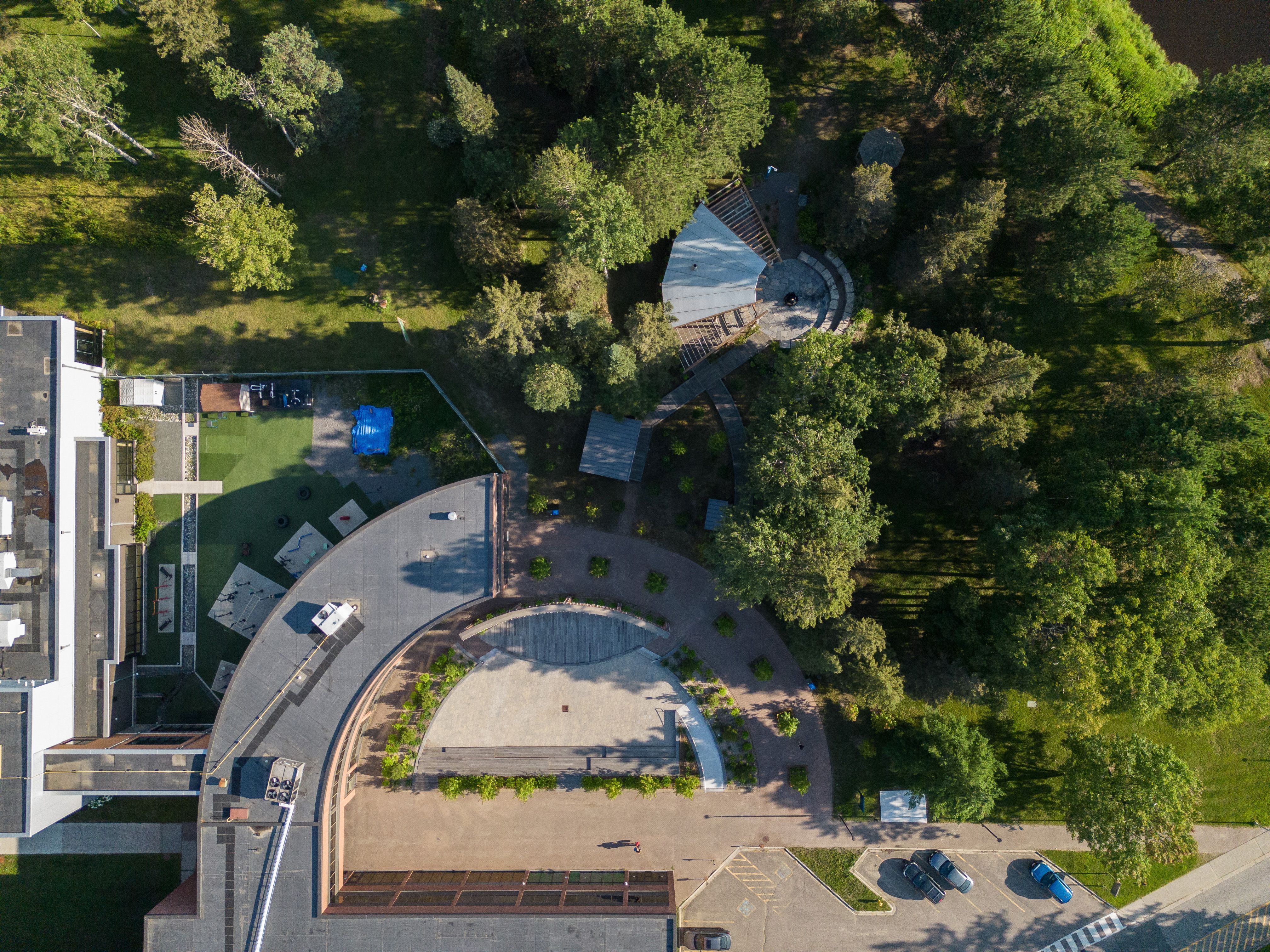 Aerial view of Confederation College outdoor gathering space surrounded by trees and walking paths