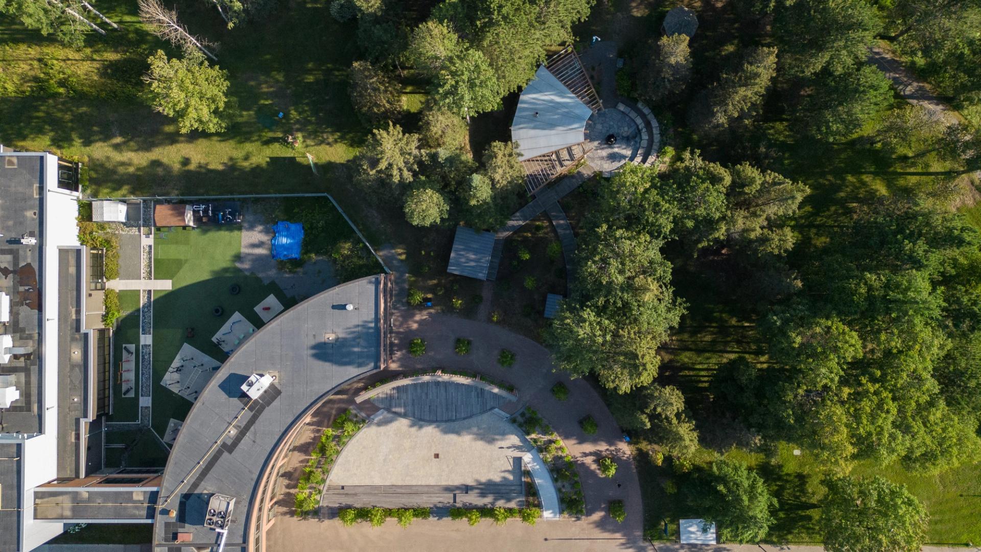 Aerial view of Confederation College outdoor gathering space surrounded by trees and walking paths