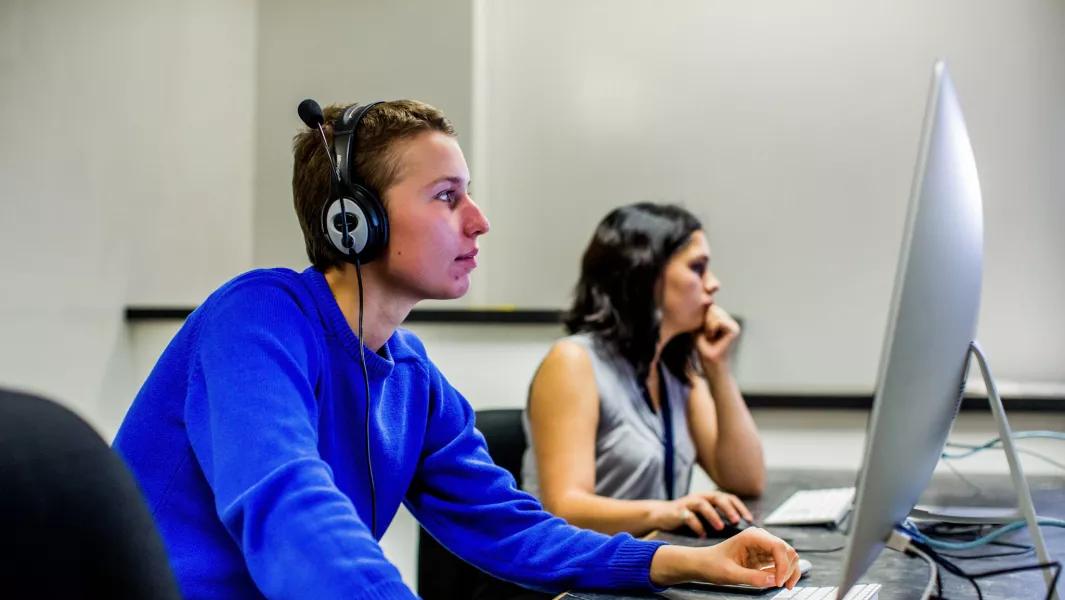 Students editing audio at computer workstations