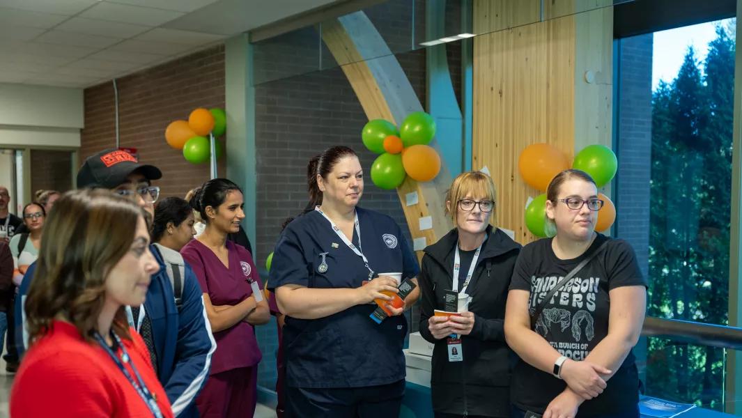 Nursing students and staff gathered in a hallway for a Confederation College event
