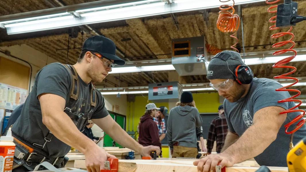 Students working on woodworking projects in the carpentry shop