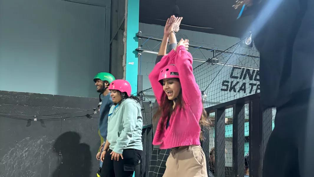 Students cheering and preparing to skate at an indoor skate park