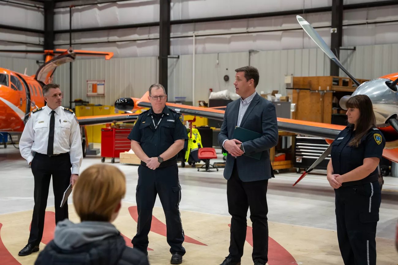 Ornge and Confederation College staff speak in a hangar during the bursary announcement