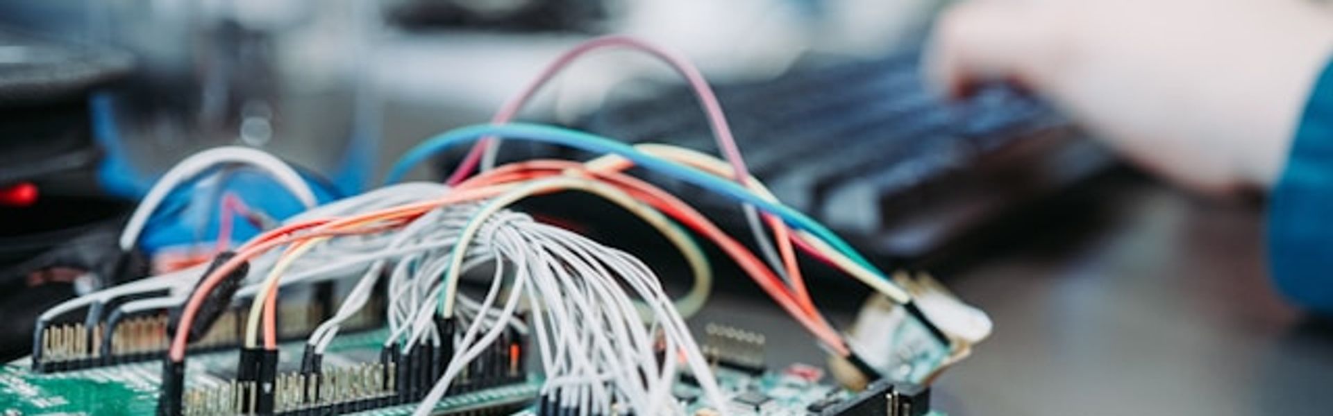 Student working with an electronic circuit board and wiring during computer engineering training