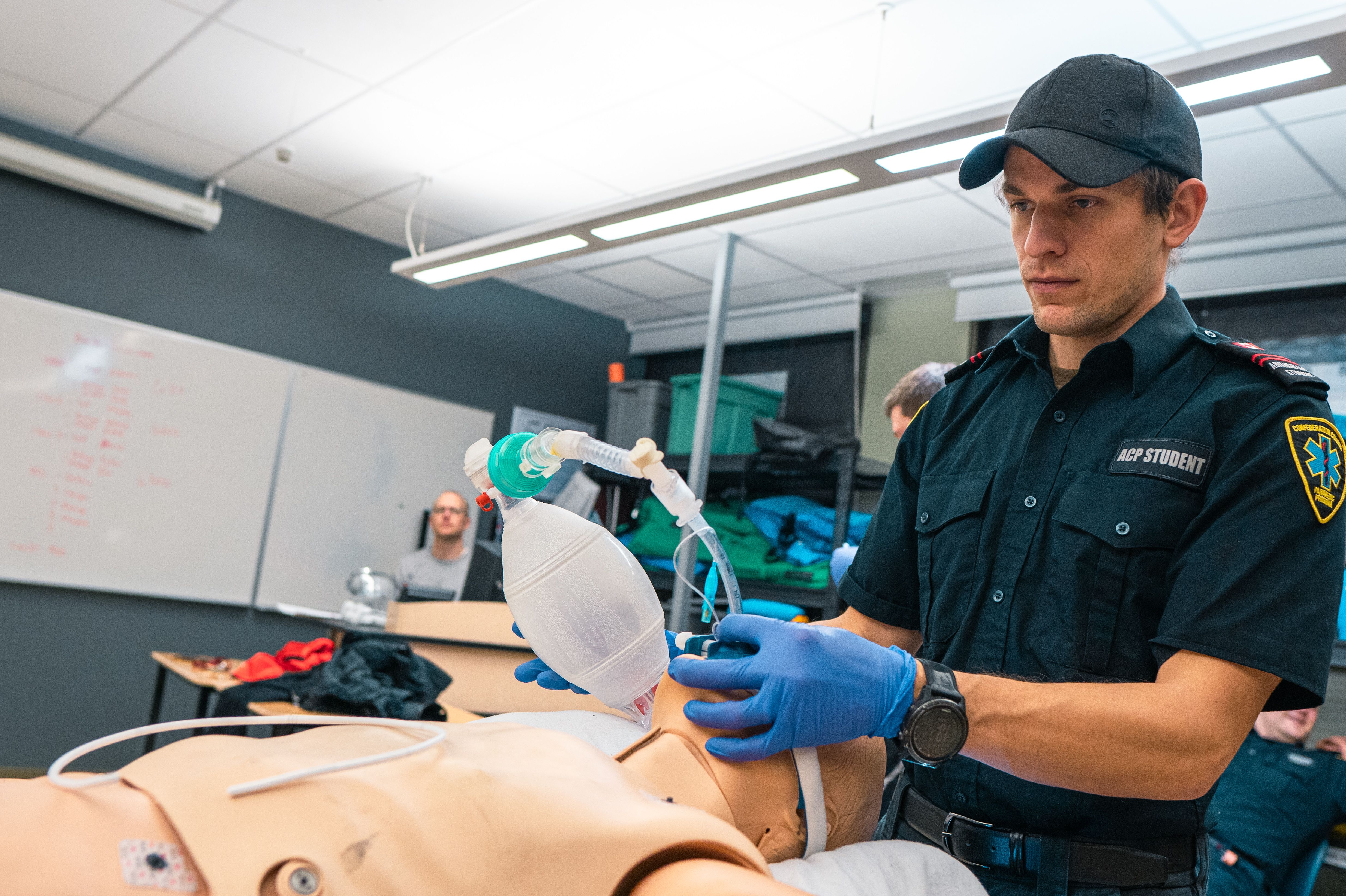 ACP students ventilating a training mannequin in a clinical lab