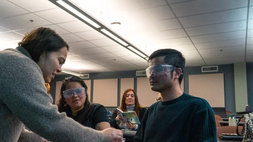 Students wearing distortion goggles while engaging in a sensory-impairment activity