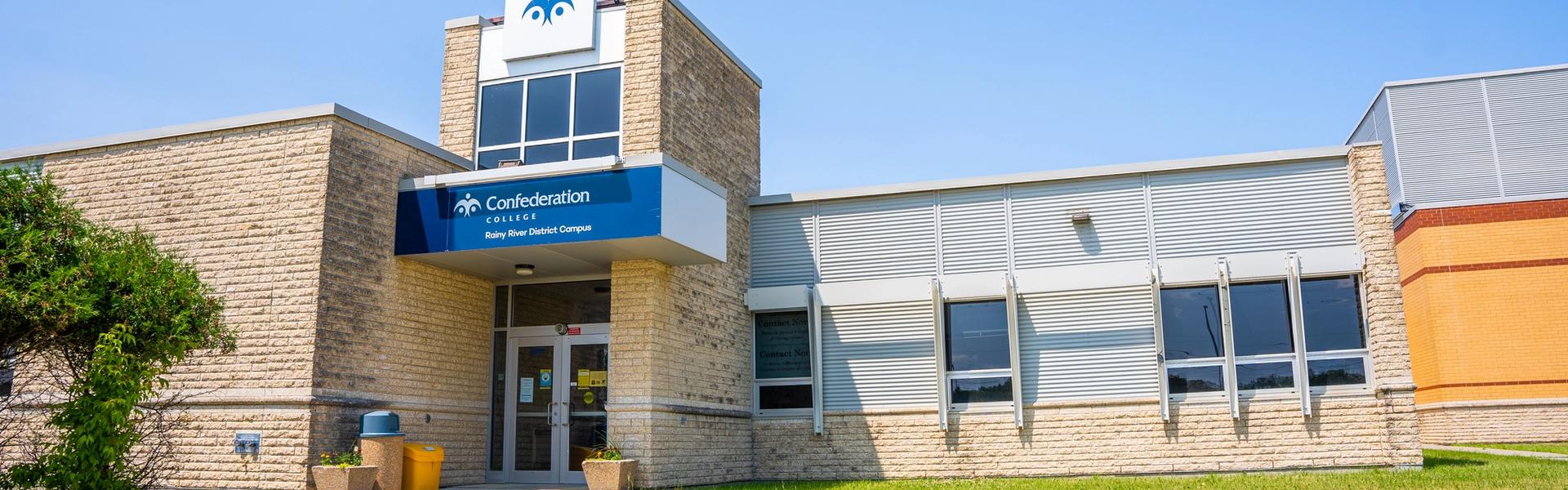Confederation College Rainy River District Campus building with a blue entrance sign and grassy foreground