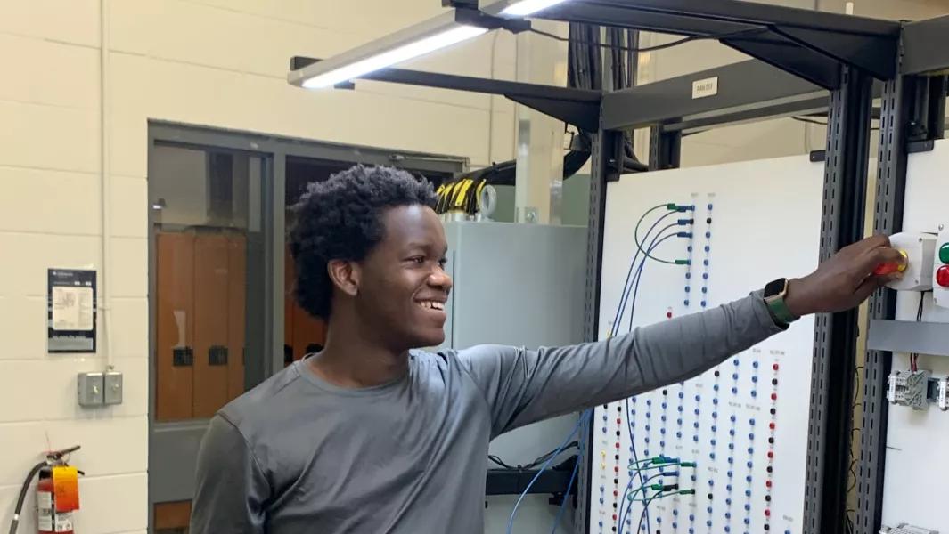 Student operating controls on an electrical training panel