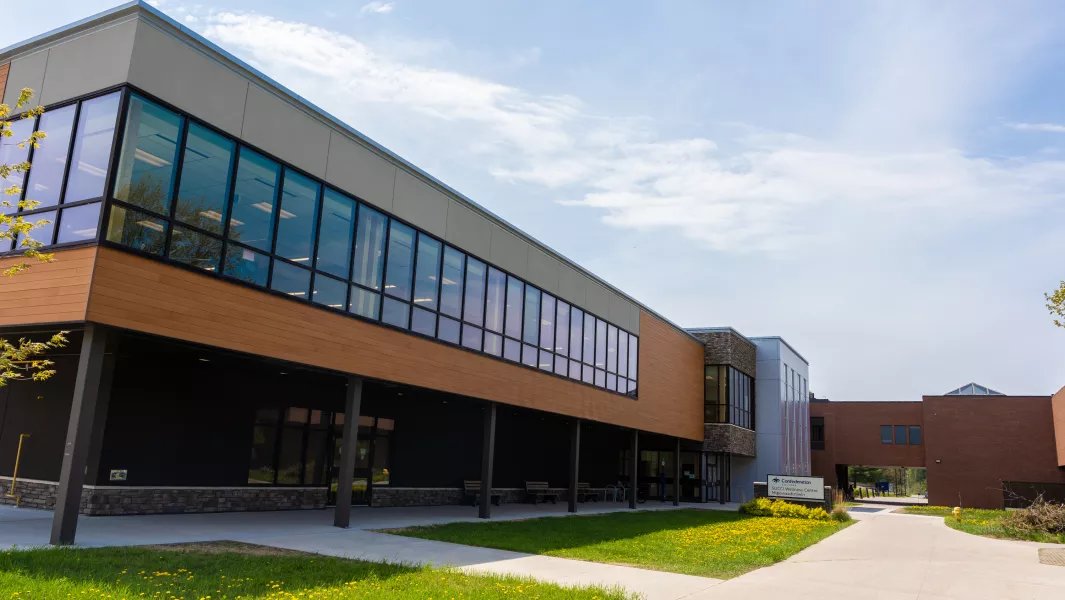 Modern campus academic building with large windows and walkway