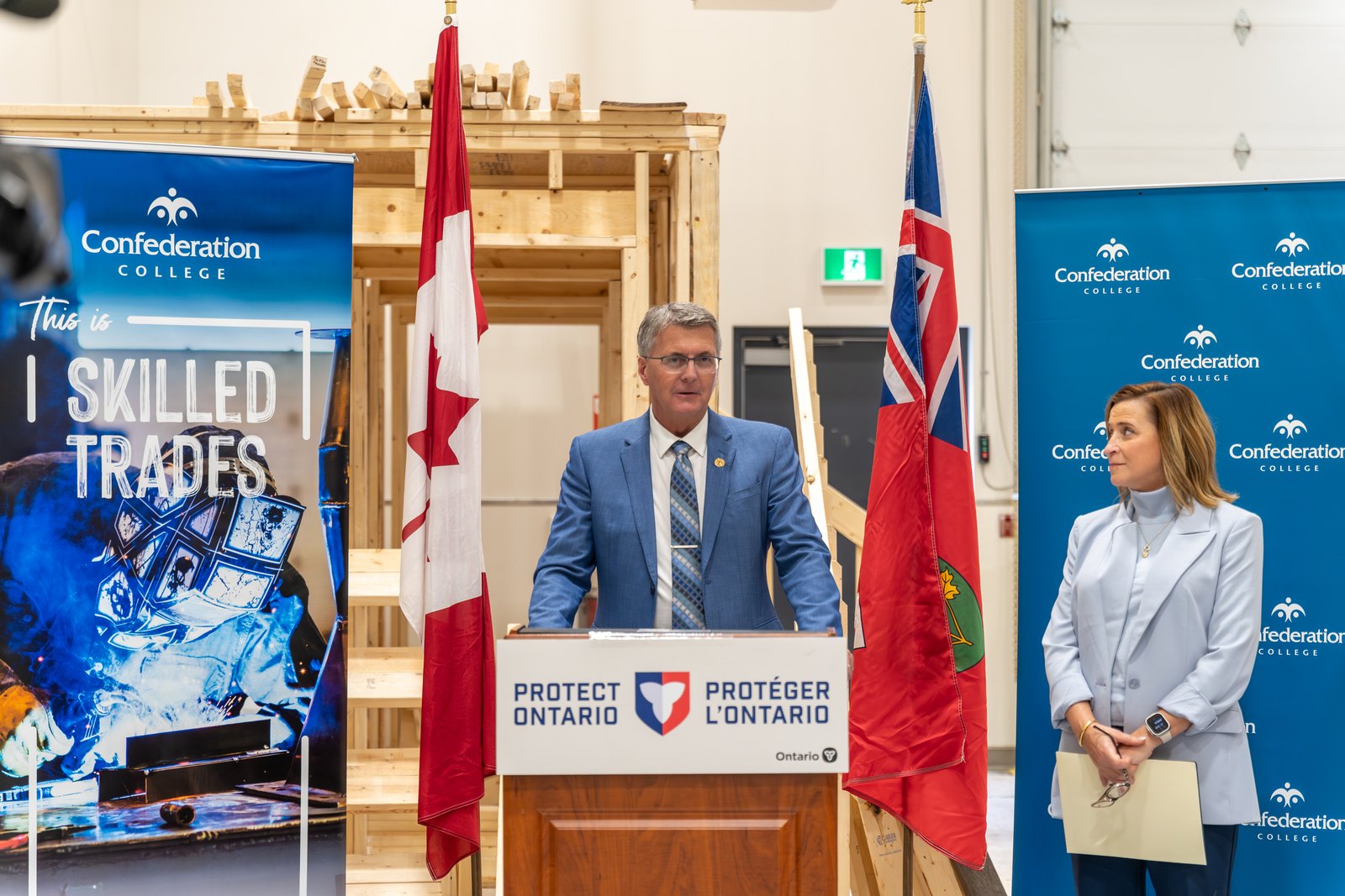MPP Kevin Holland announces Ontario funding for skilled trades training at Confederation College with officials present.