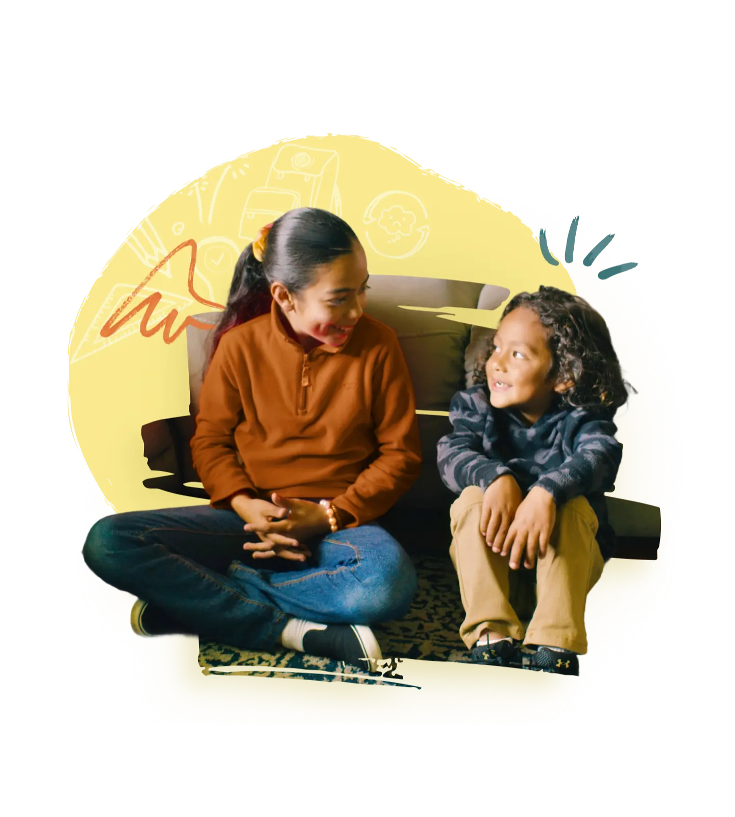 Two young children sitting together, smiling and looking at each other, promoting early learning and resilience building