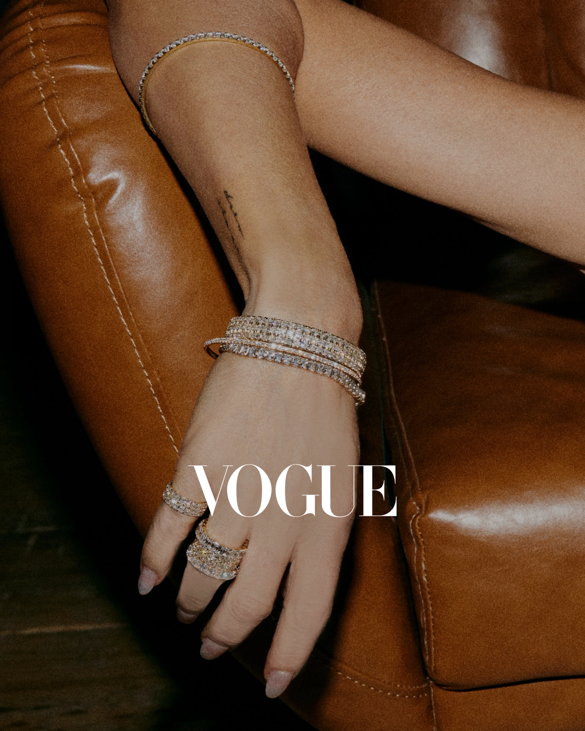 Jennifer fisher's wrist with lab diamond bracelets and rings stacked 