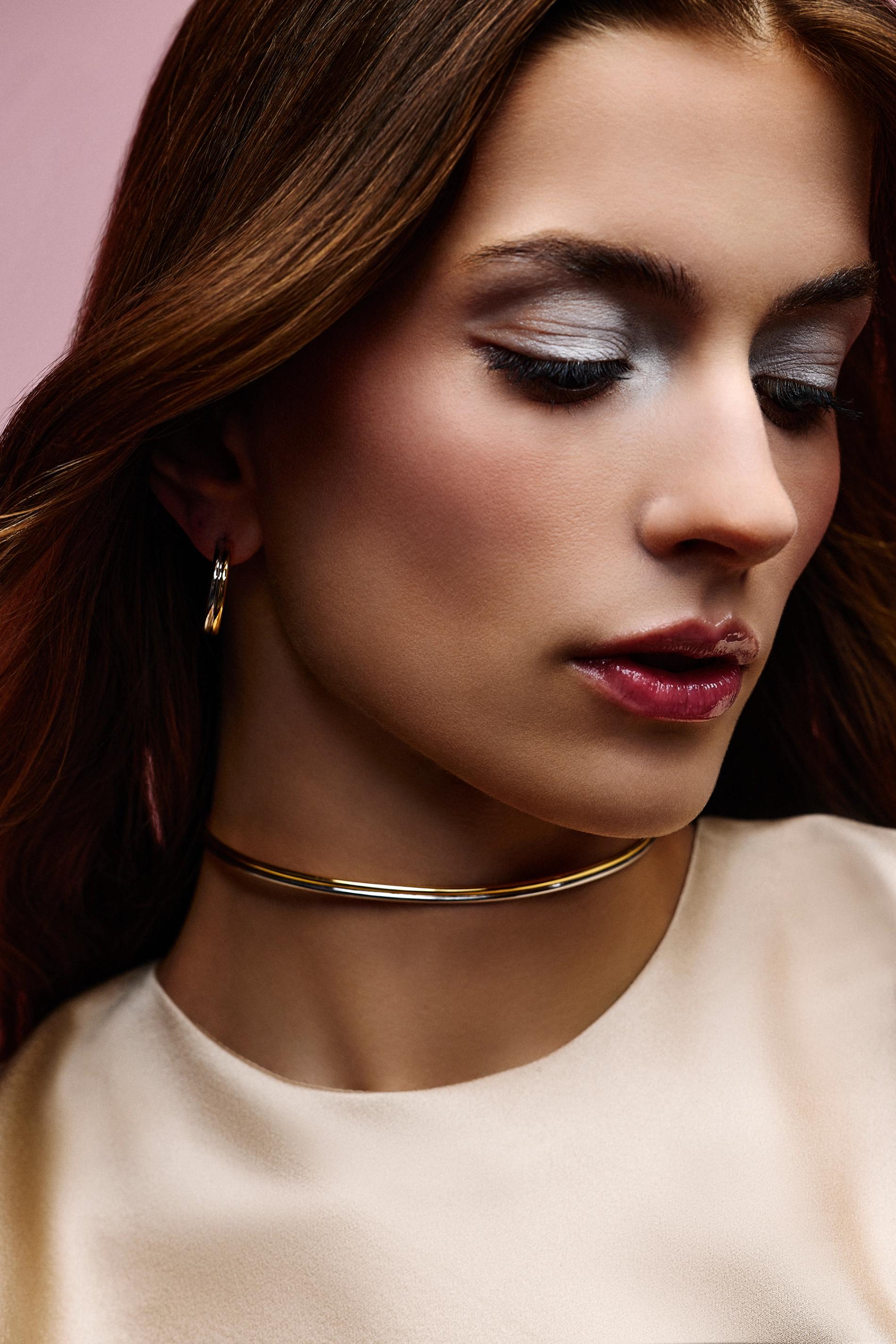 Model with silver and gold hoop and choker on