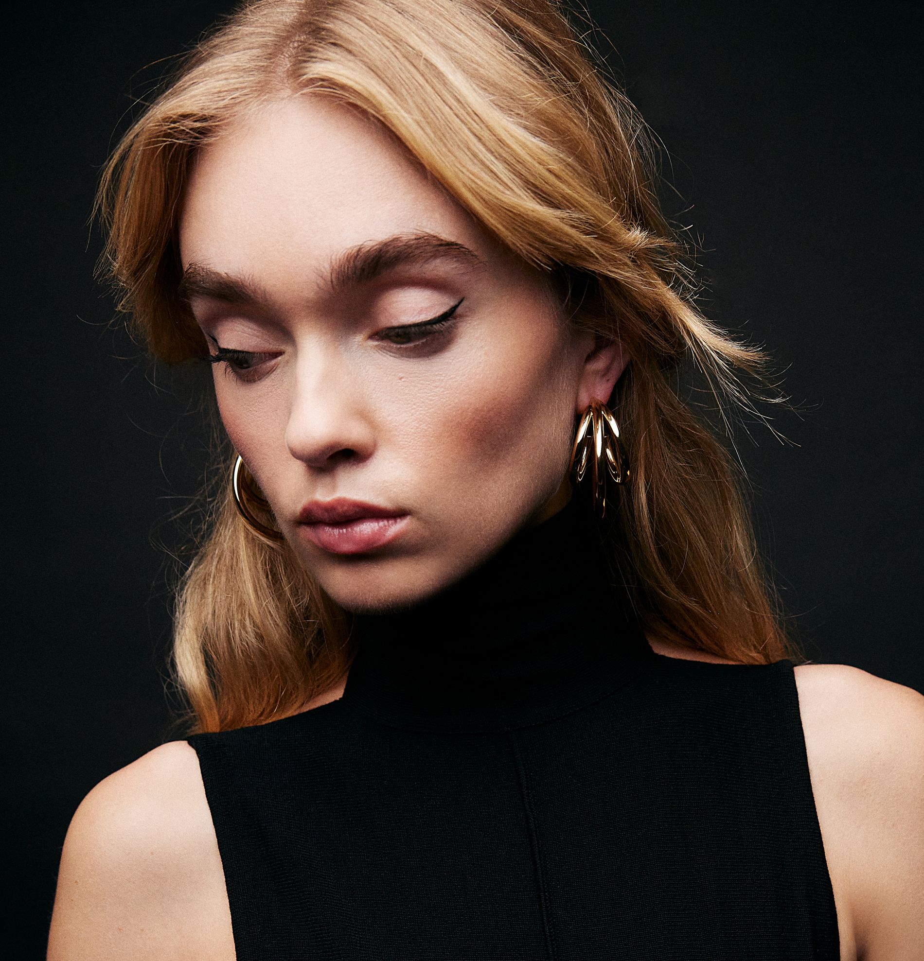 model in lightweight gold hoops