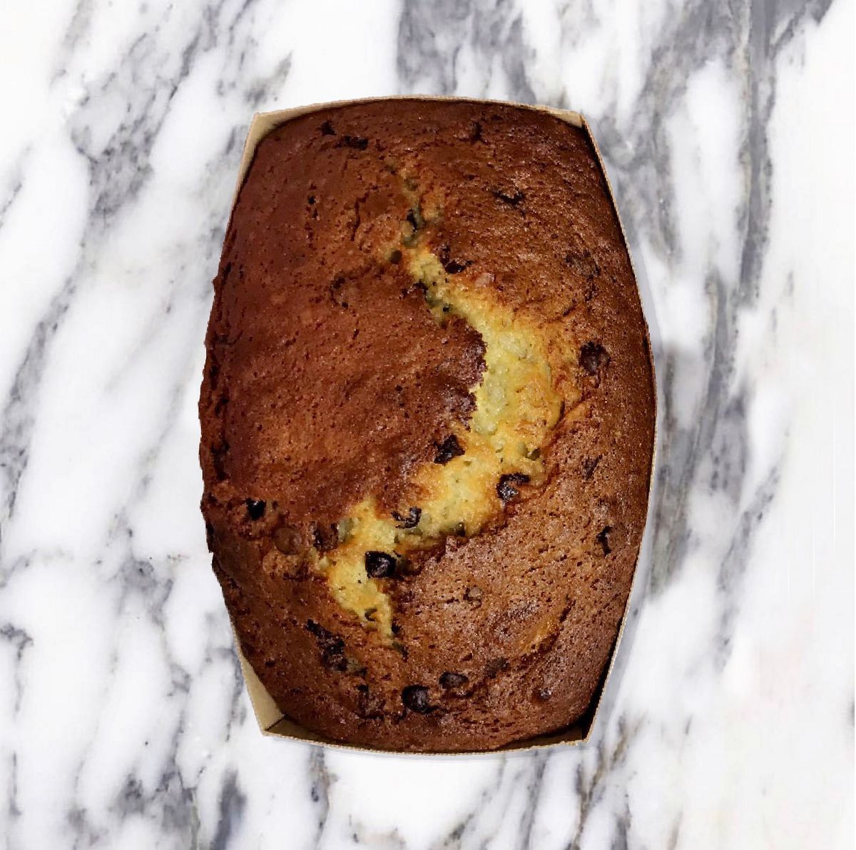 Banana bread with chocolate chips on marble countertop