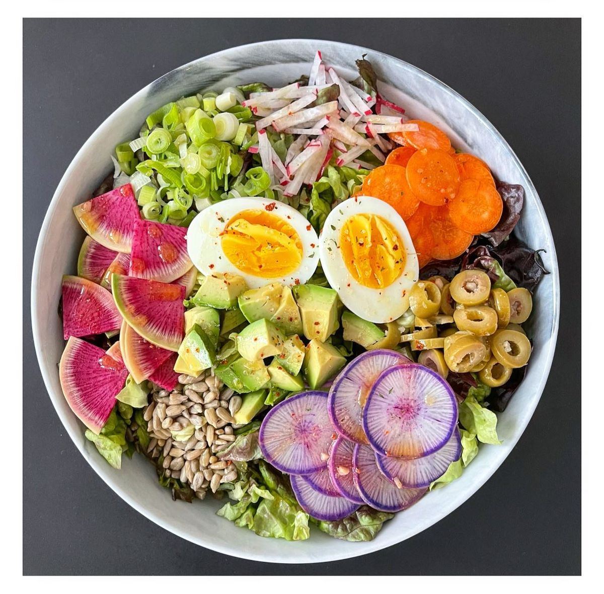 bowl of salad with vegetables and boiled egg