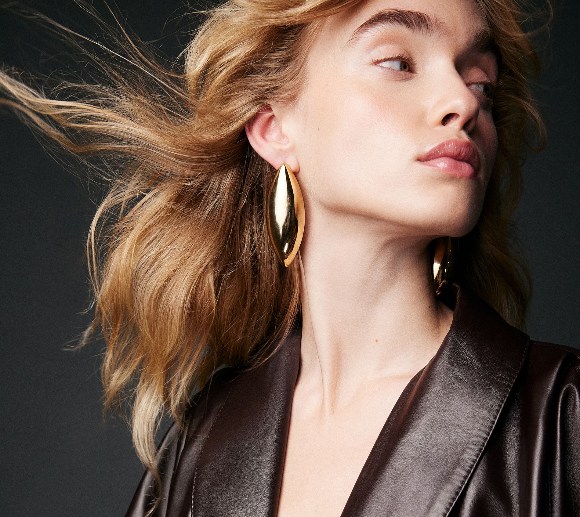 model in a chunky gold earring