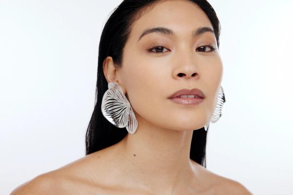 woman wearing large flower earrings
