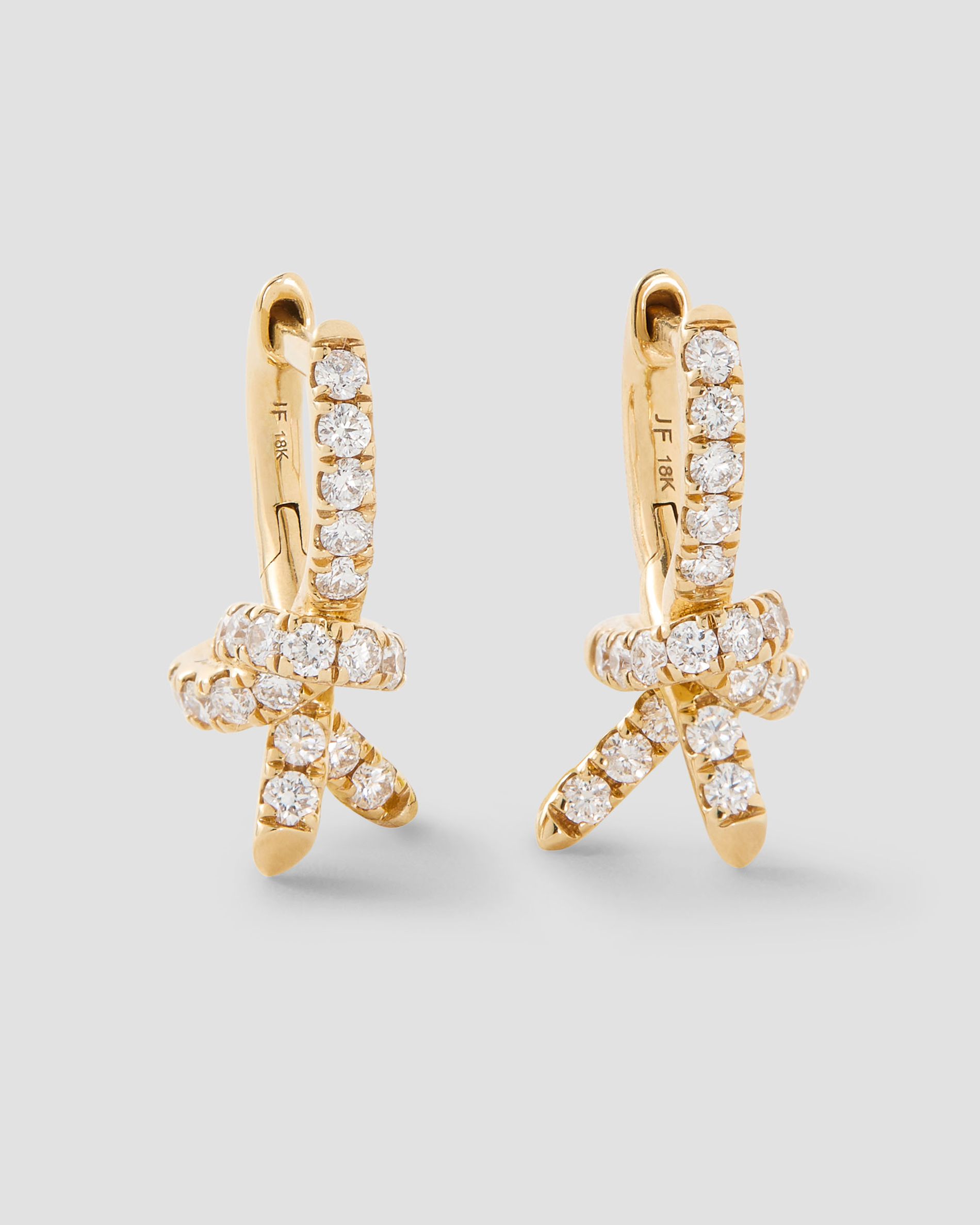 product shot of knot huggies with diamonds encrusted