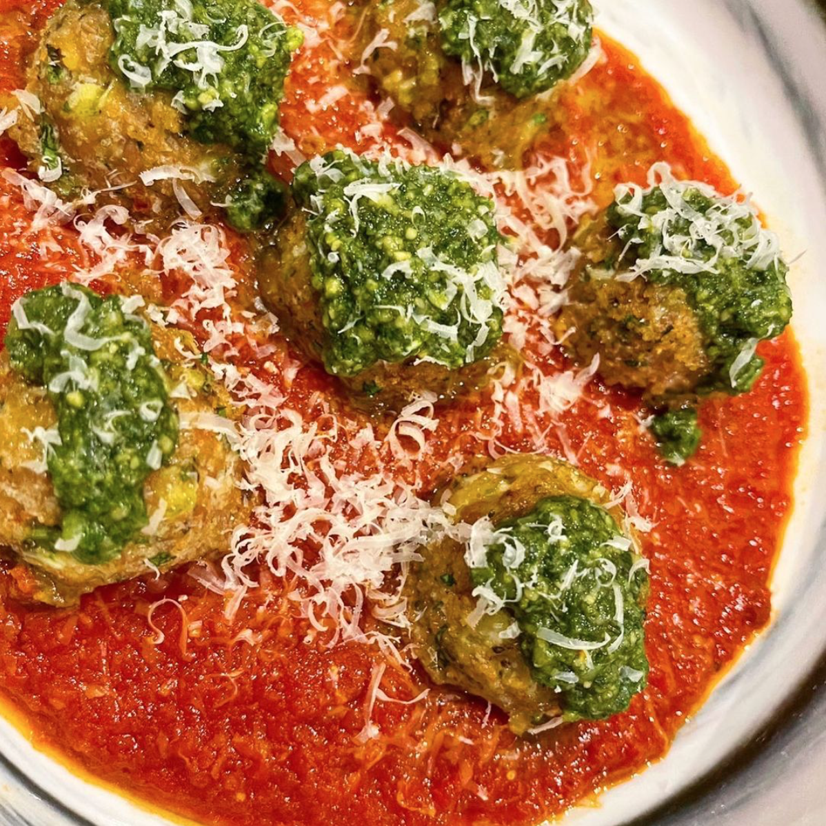 Turkey meatballs in tomato sauce with pesto on top