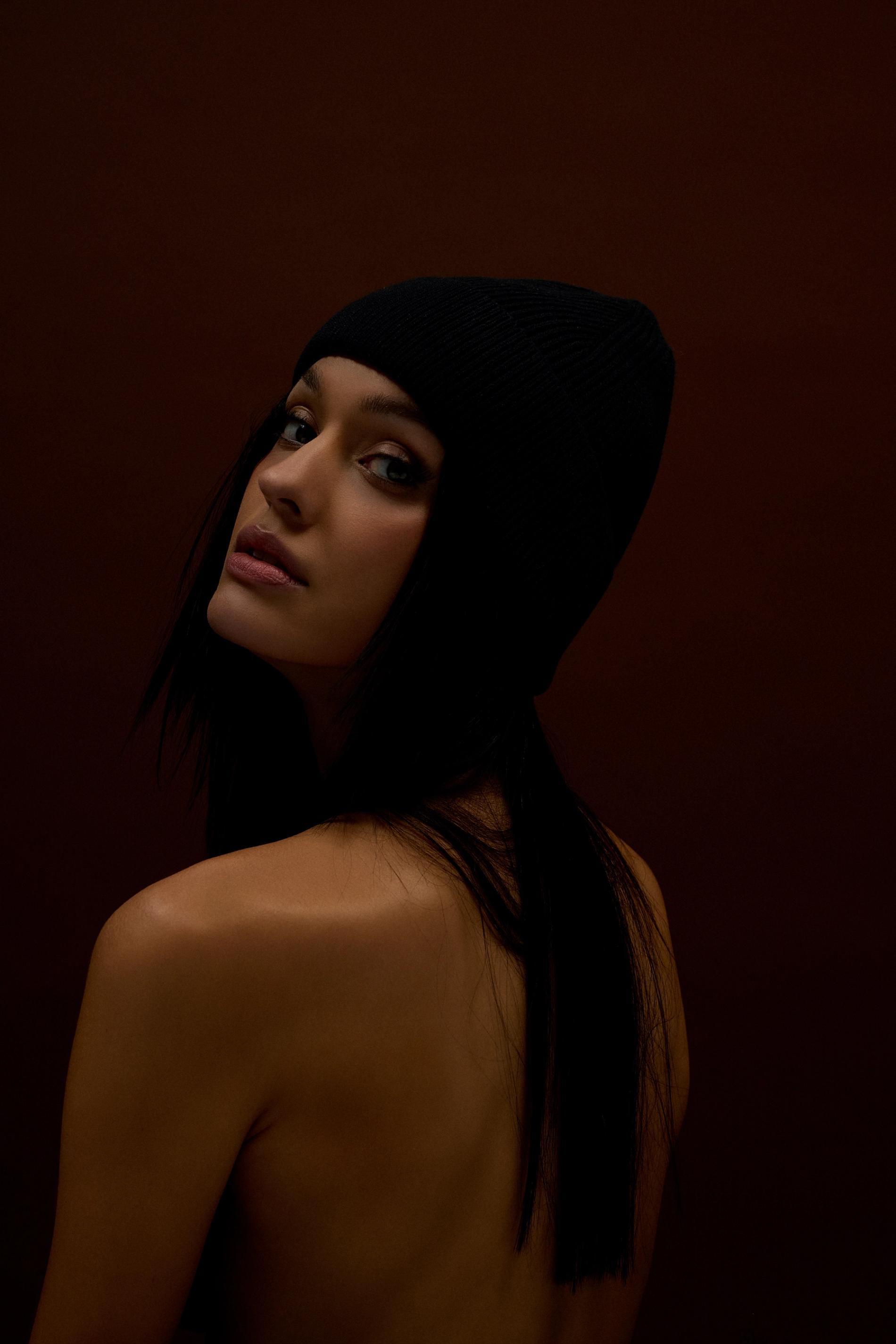 Jennifer fisher on a chair holding trust your gut, her cookbook