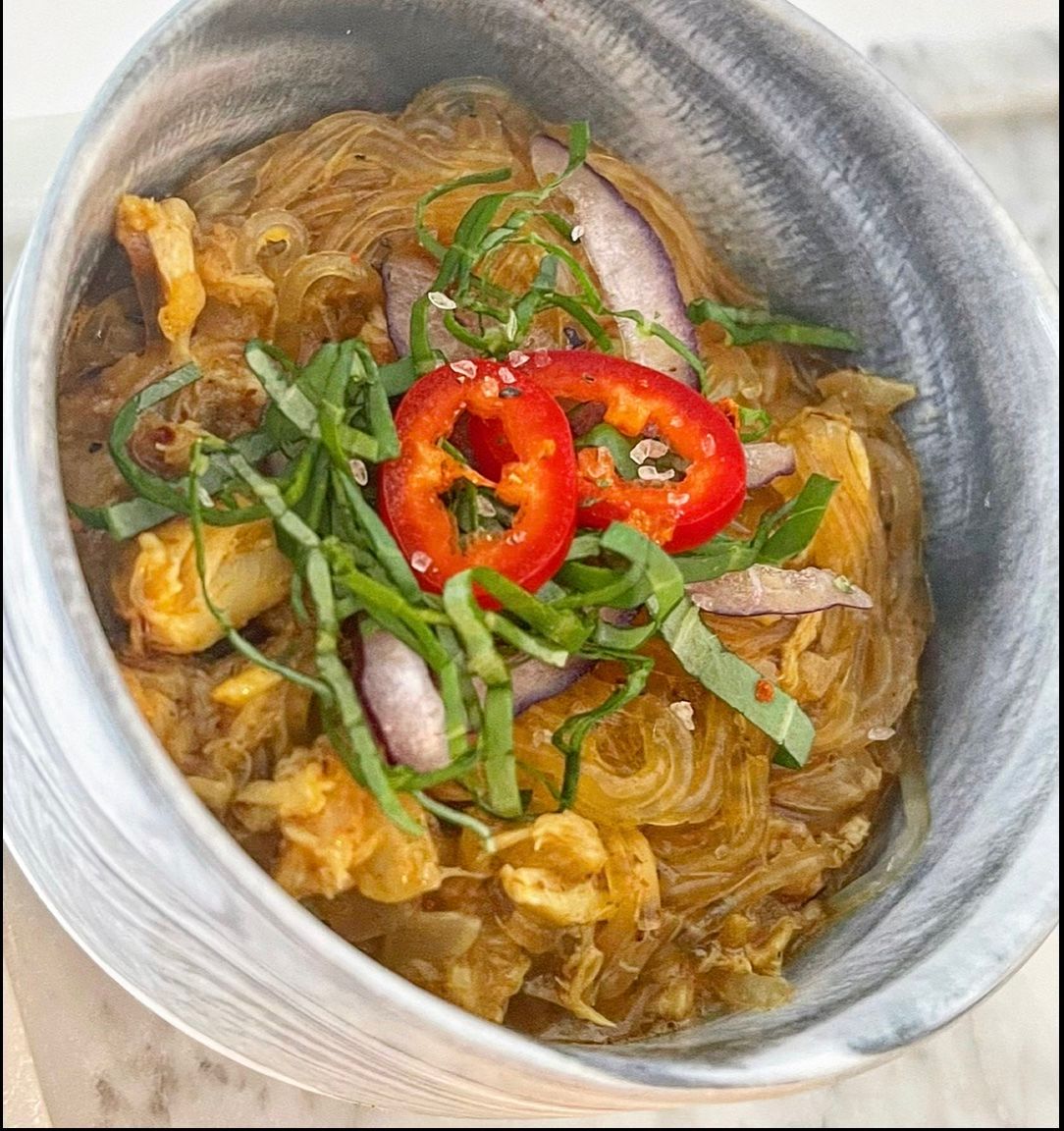 Image of noodles in a bowl with toppings