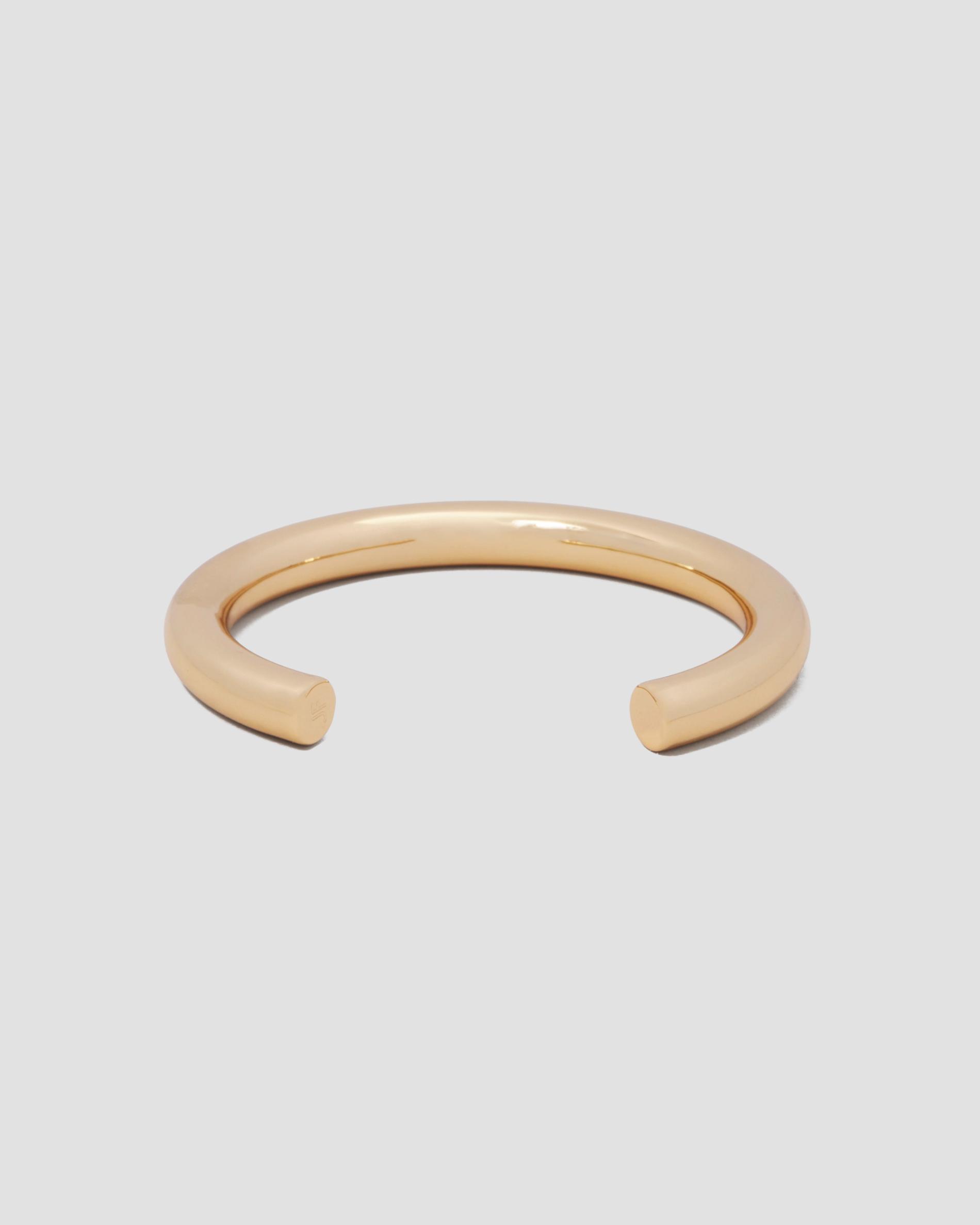 gold bangle cuff on a grey background