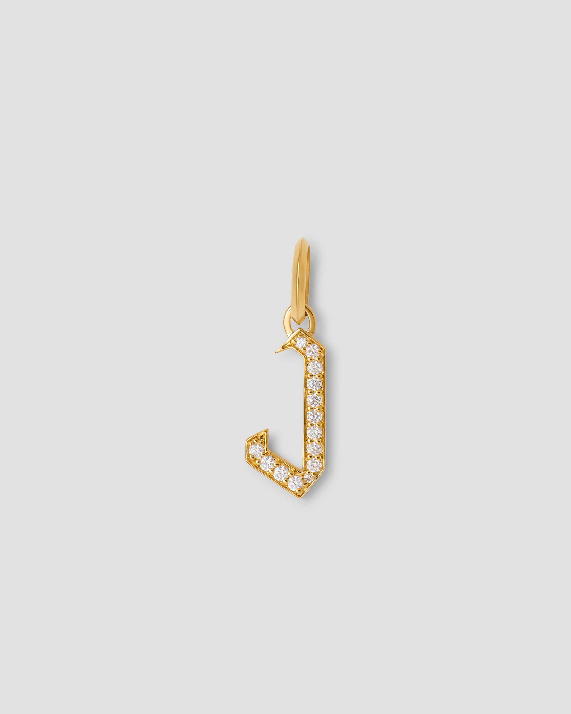 capital gothic letter J charm with diamonds on a grey background