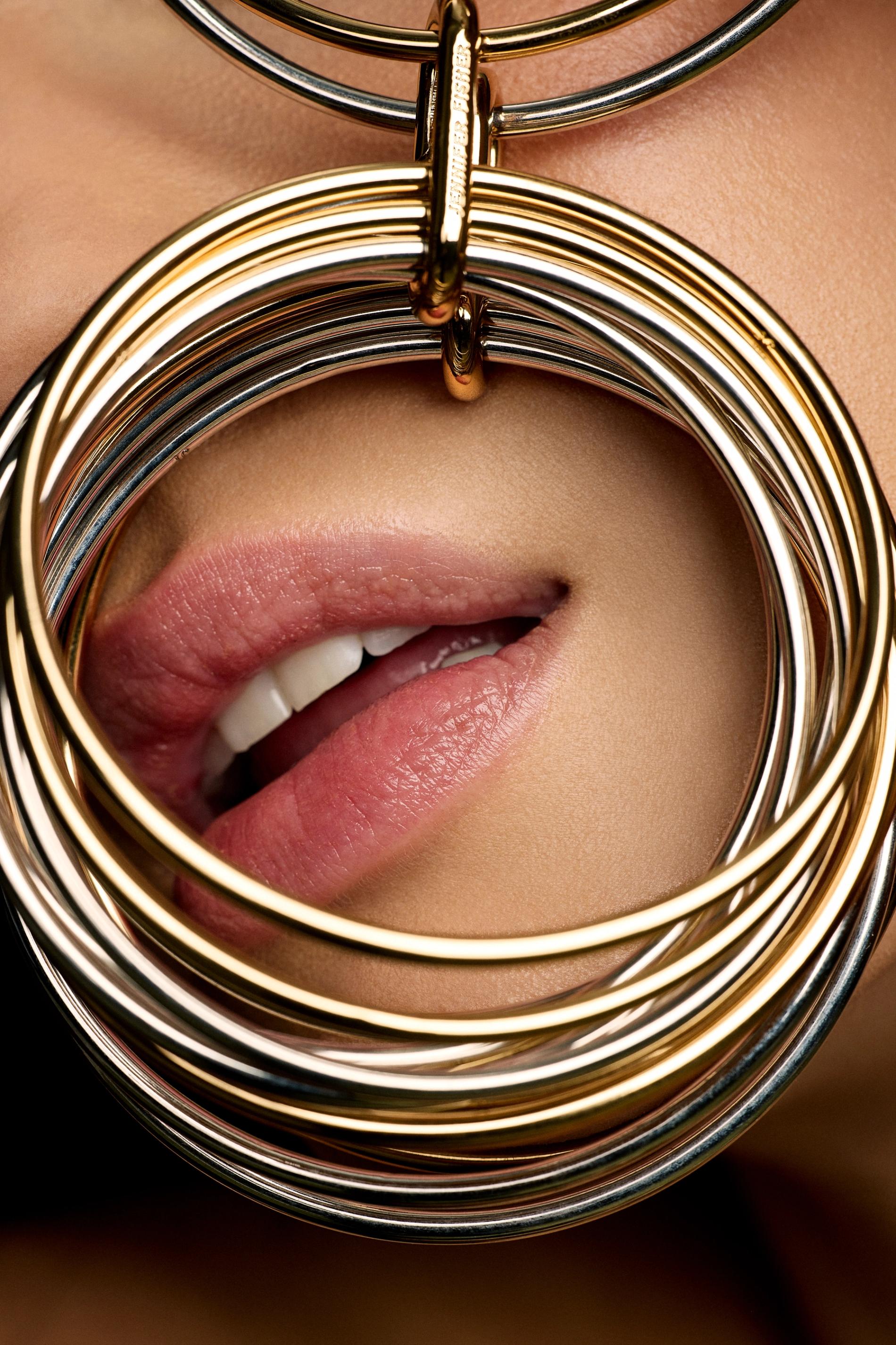 model with bangles covering mouth