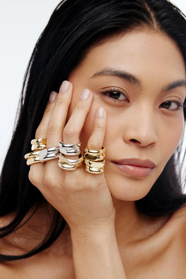 woman wearing stacked rings on many fingers