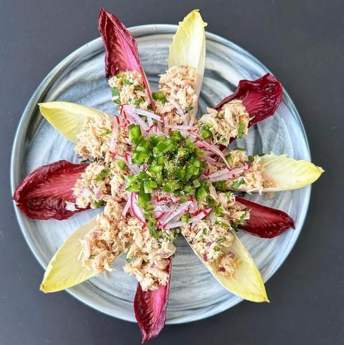 Endive leaves filled with mayo-free tuna salad topped with radish, jalapeño and JF Spicy Salt