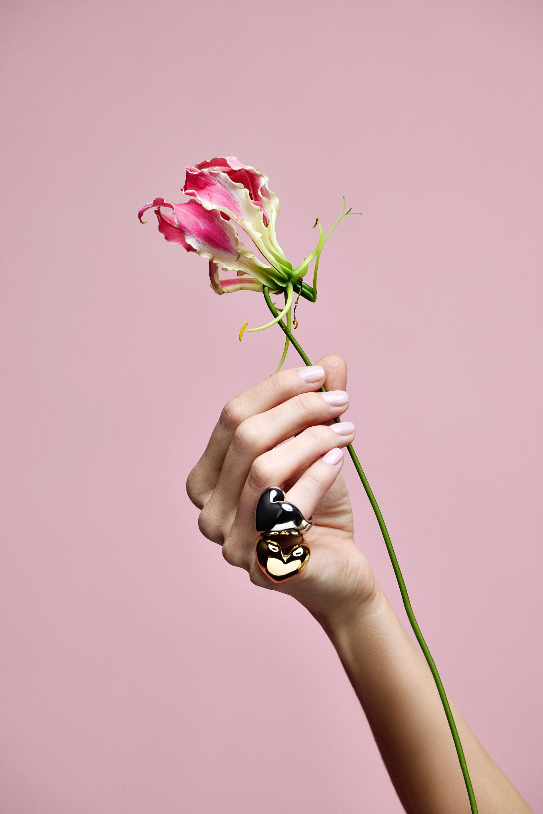 Gold chains and charms on a grey background