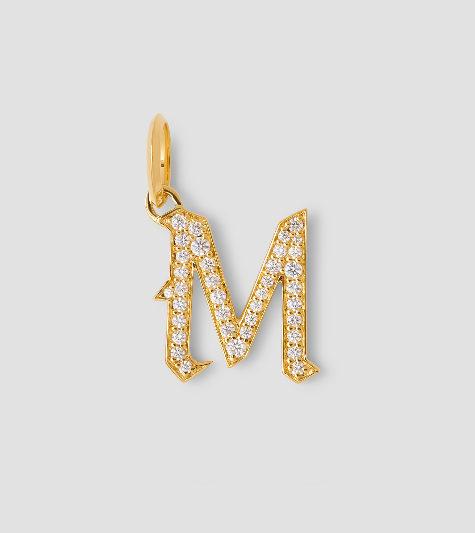 Diamond M captial charm on a grey background