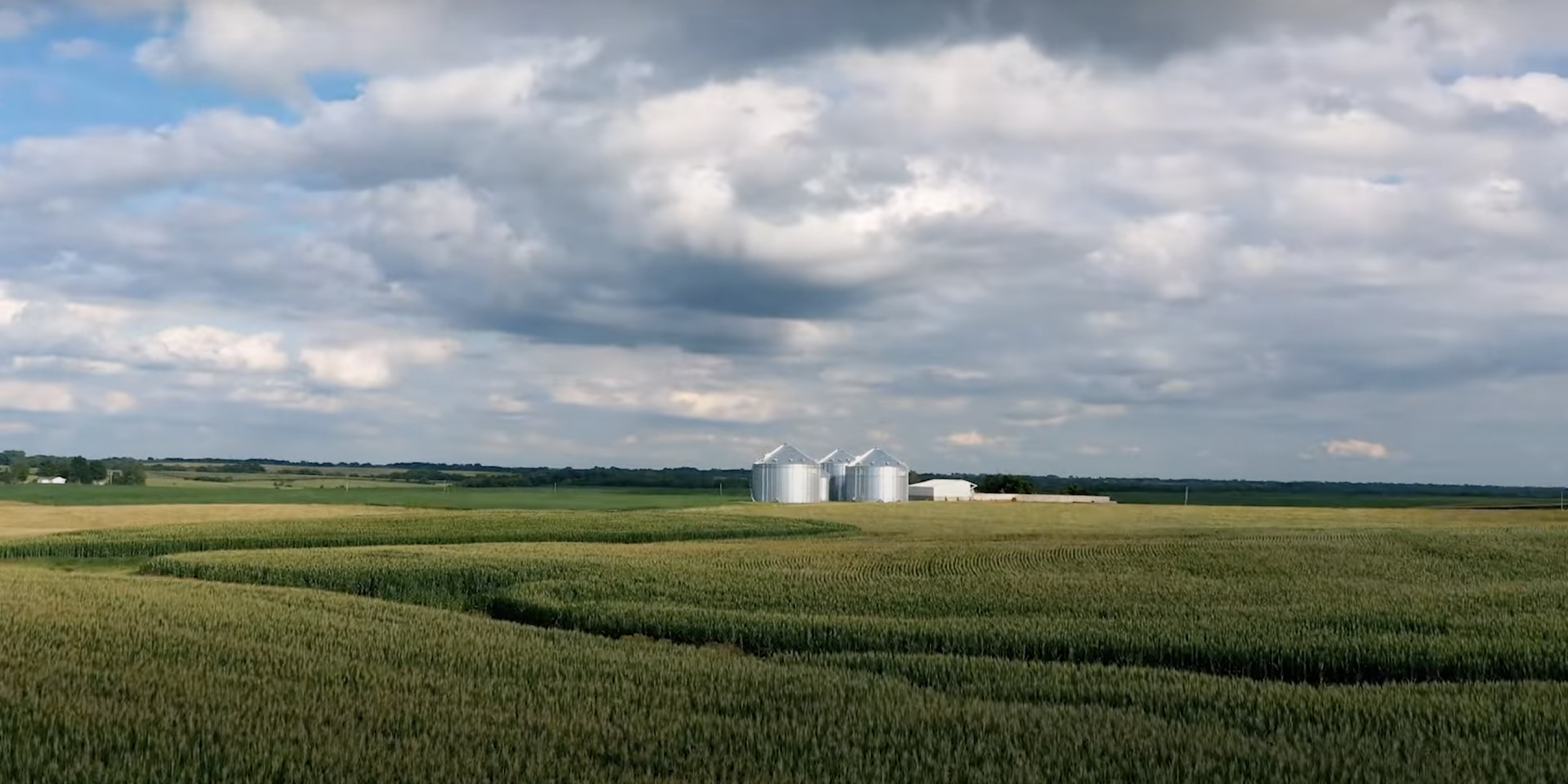 Video preview image of a farm with grain silos in the background