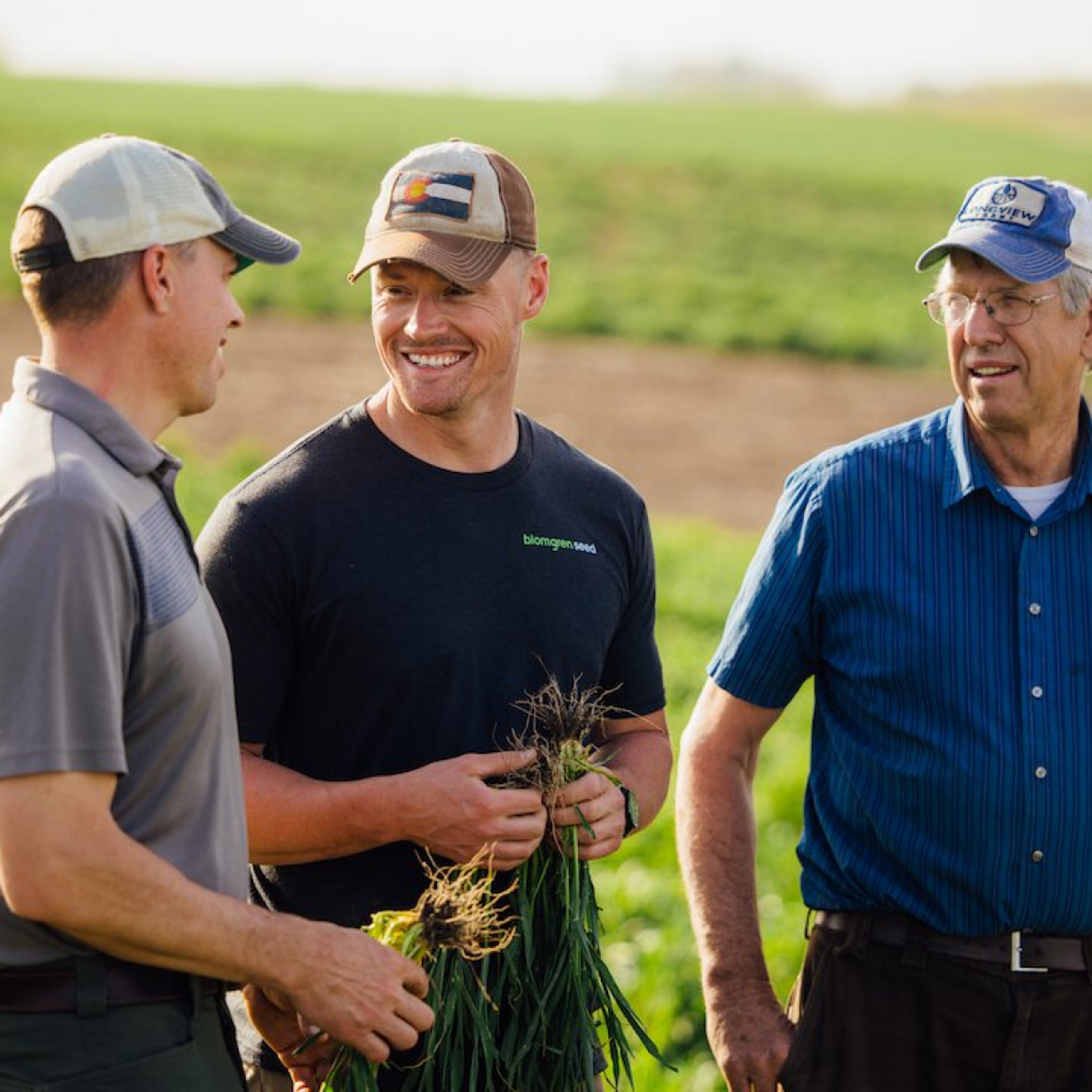 Farmers & Pivot Bio Representative Holding Crop Roots & Talking