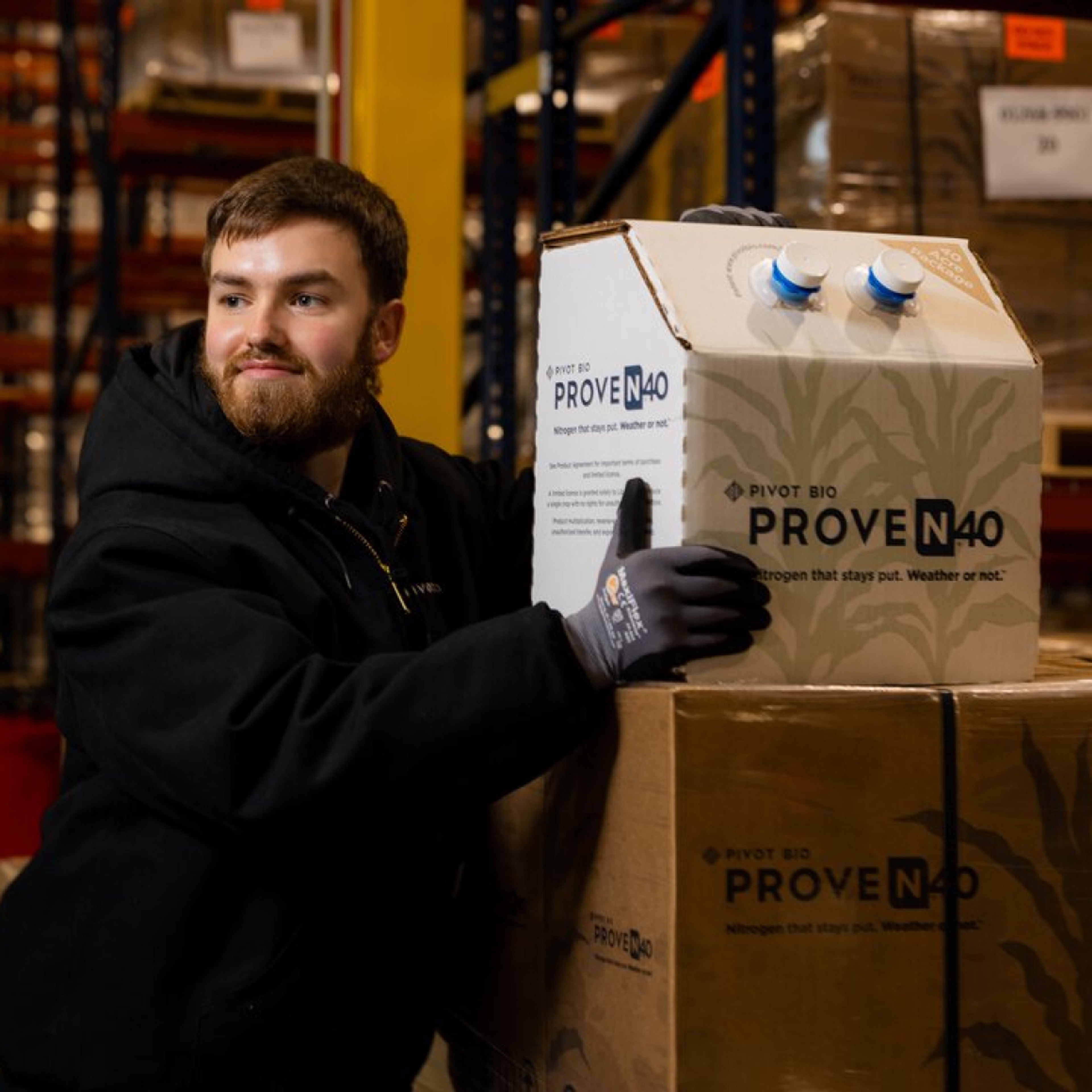 Pivot Bio fulfillment center employee holding a Proven 40 box