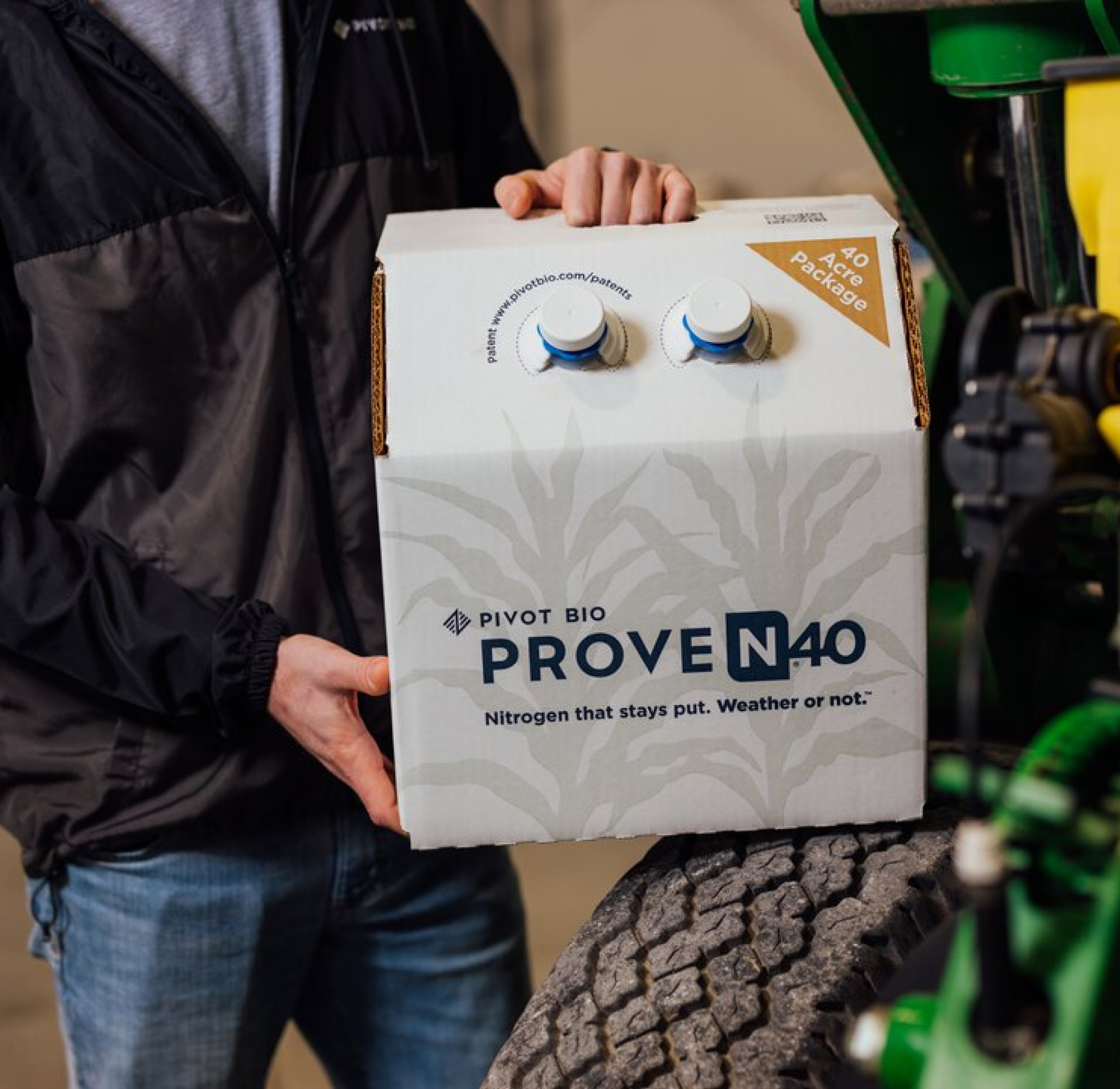 Person holding a box of Proven 40 Product on a tracker wheel